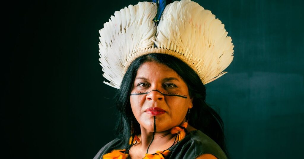 indígena Sônia guajajara com pintura no rosto e cocar característico dos índios